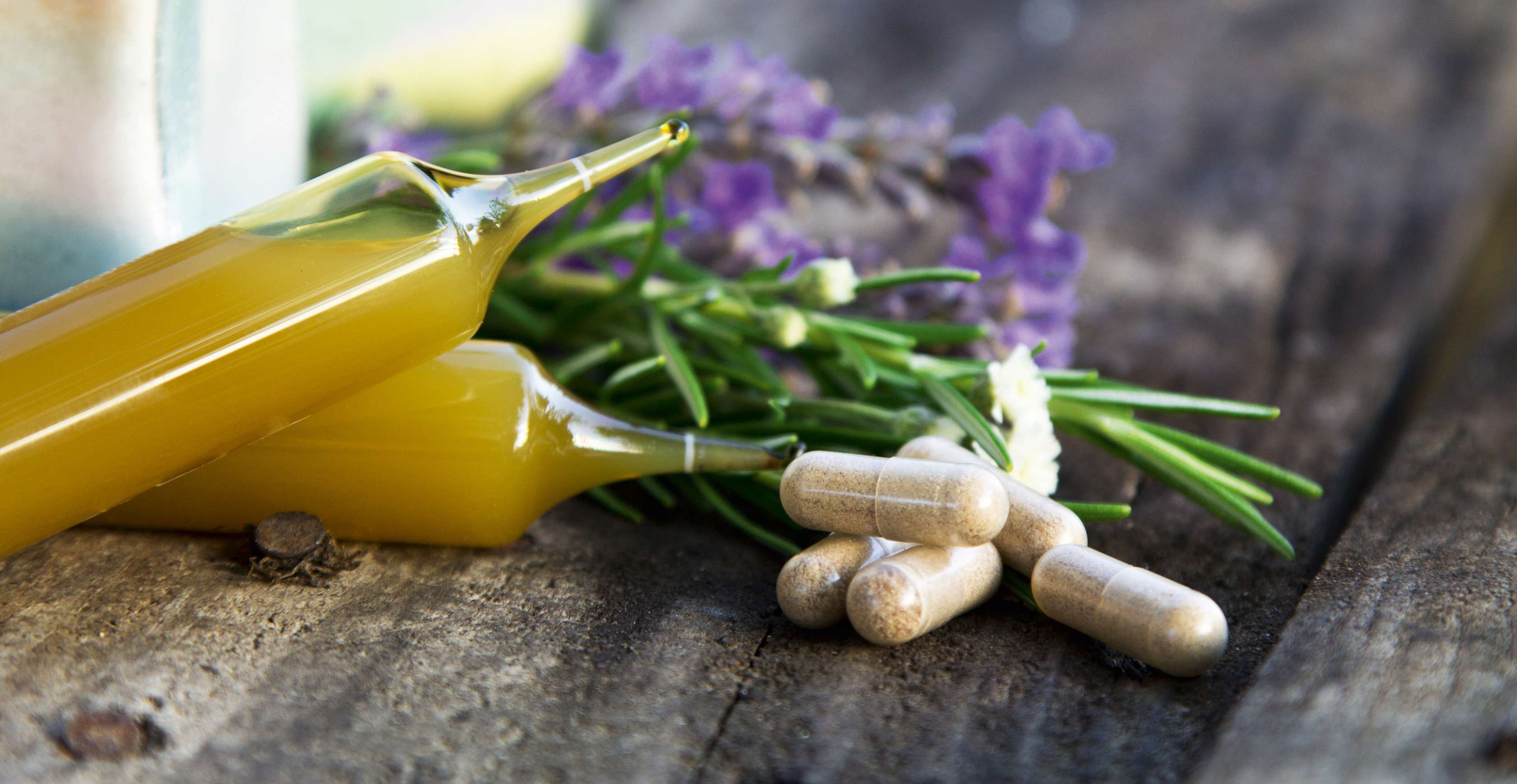 Allianz Gesundheitswelt - was sind Arzneimittel: verschiedene Arzneimittel - in Form von Kapseln und Ampullen - liegen auf einer Arbeitsplatte.